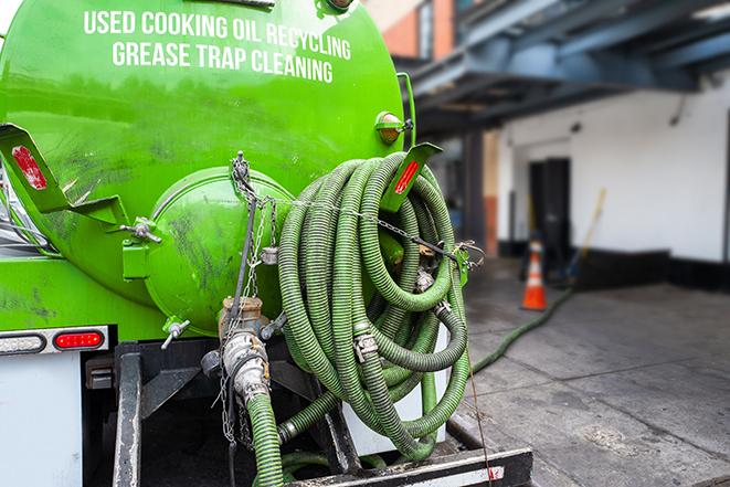 grease trap pumping truck servicing a restaurant in Eustis FL